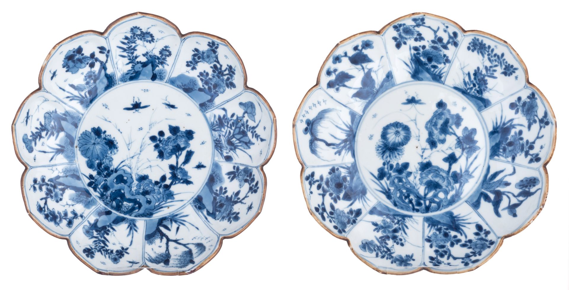 Two Chinese blue and white magnolia flower shaped saucers, decorated with rocks, flowering branches