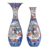 A large pair of Japanese polychrome floral vases, overall decorated with birds and an animated scene