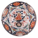 A large Japanese Arita Imari plate, central decorated with a flower basket on a terrace, the border