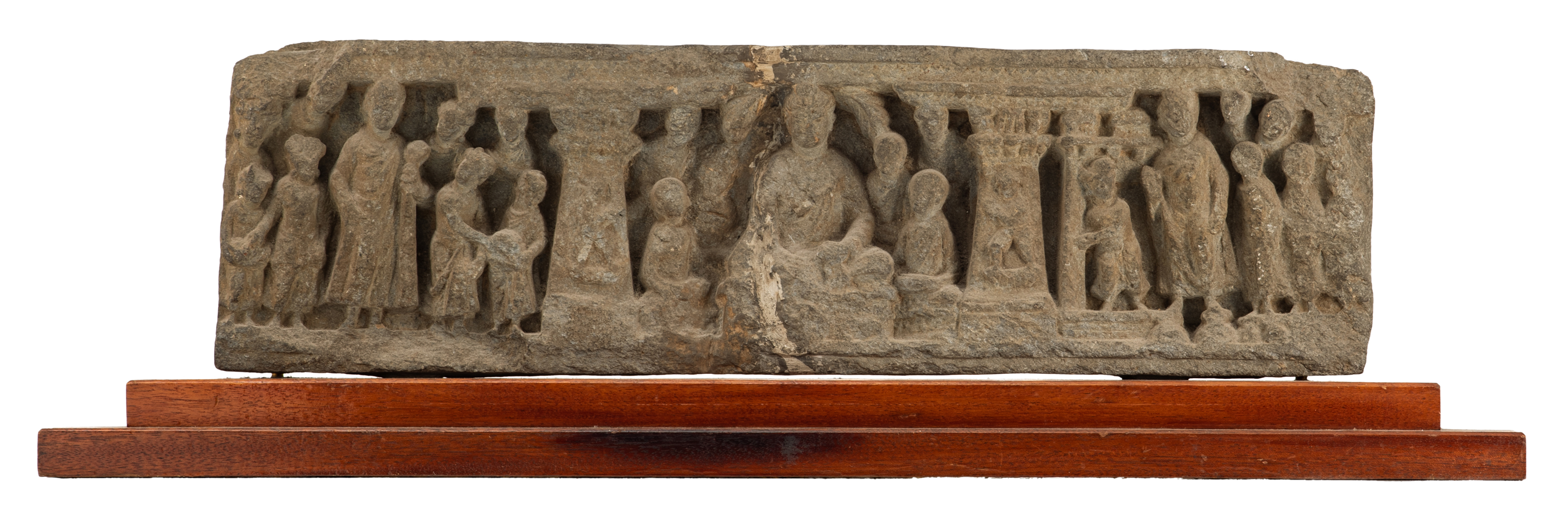 A stone fragment of a temple depicting a Buddha and his students on a mahogany base, 'Schist', Greco