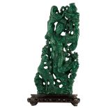 A Chinese richly carved malachite group, depicting a lady holding a basket, and a mythical bird, on