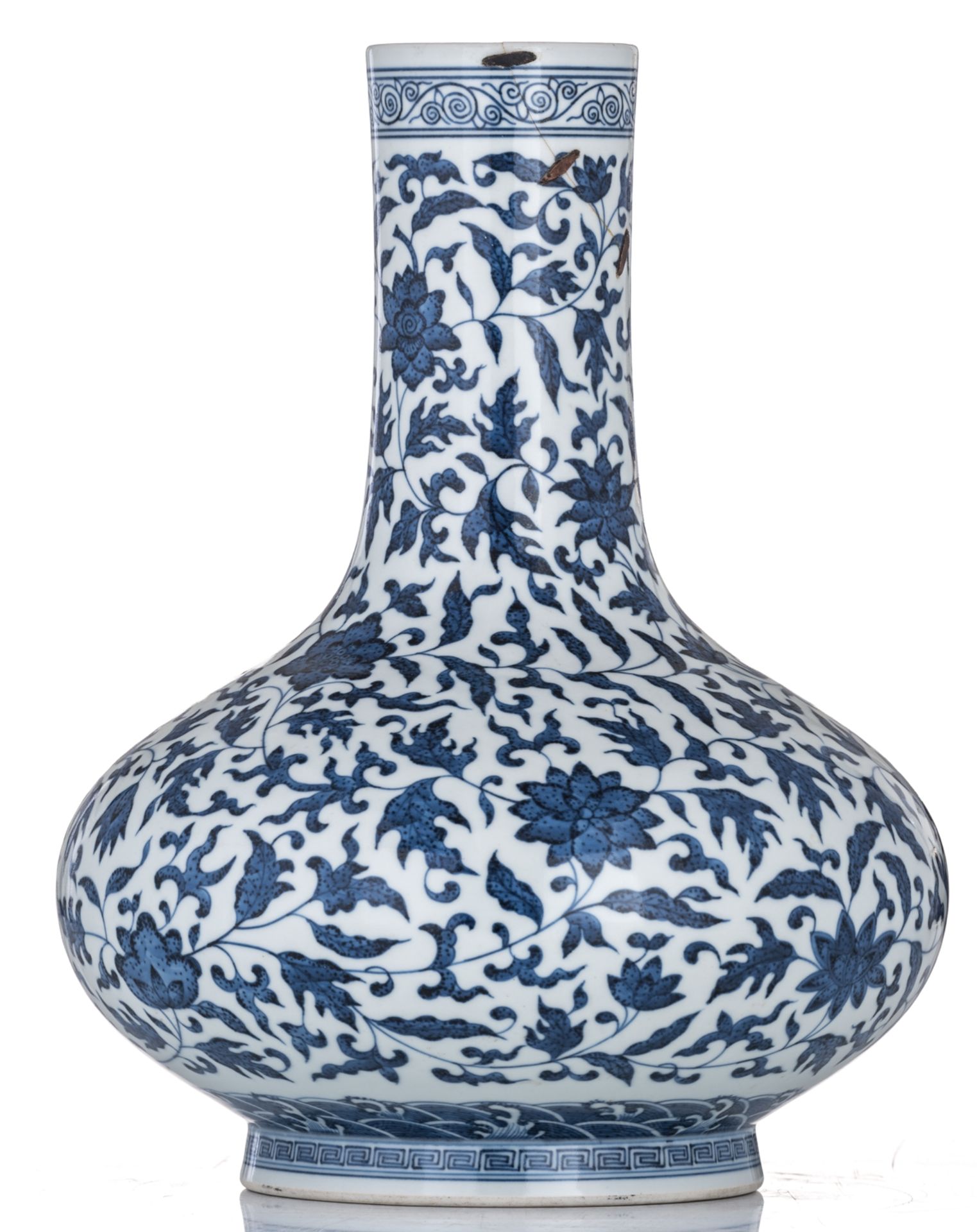 A Chinese blue and white bottle vase, decorated with scrolling leaves, with a Qianlong mark, 19thC, - Image 2 of 6