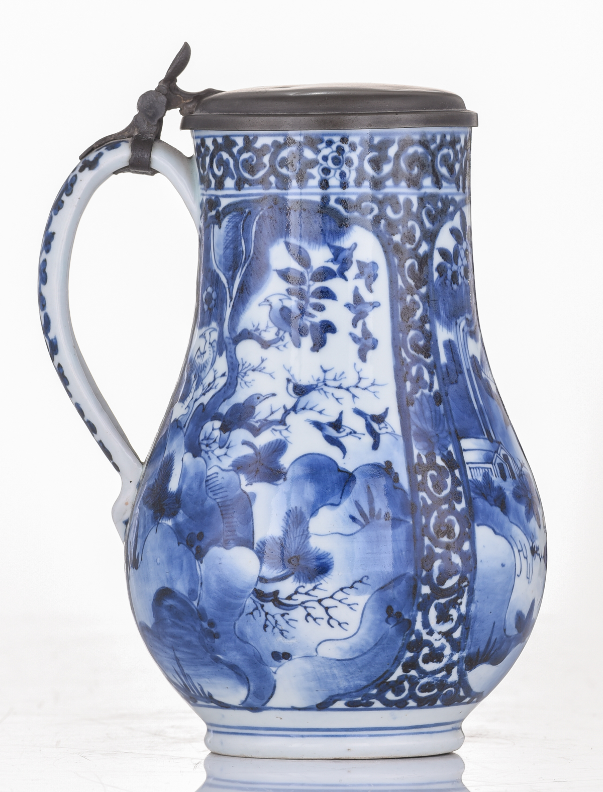 A Japanese Arita Imari blue and white tankard, decorated with scrollwork and panels, filled with fig - Image 4 of 7