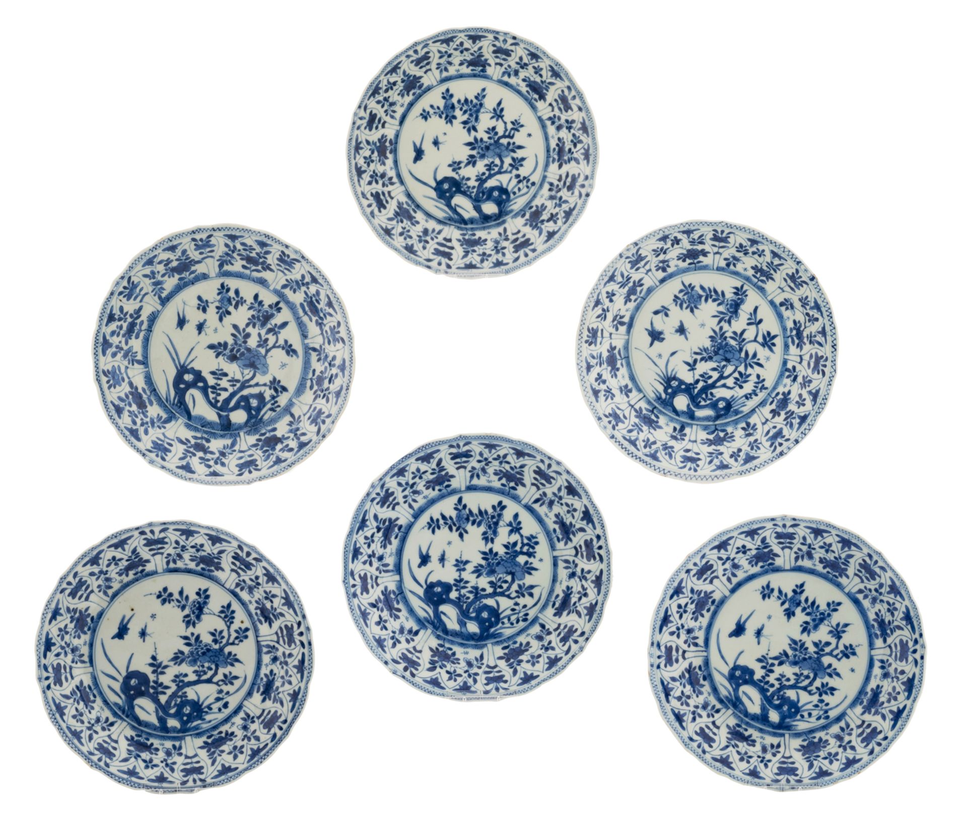 A lot of six Chinese porcelain blue and white saucers, decorated in the centre with rocks and peony