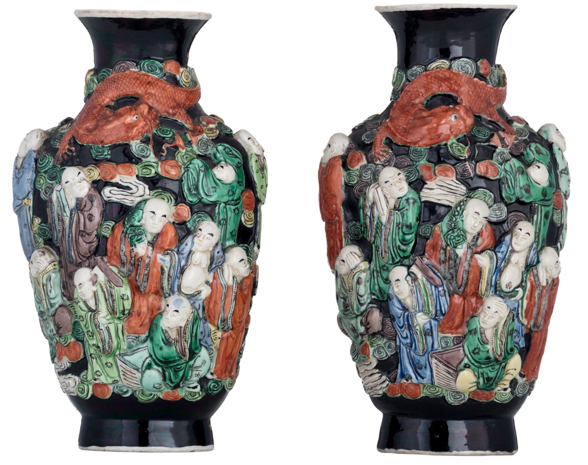 A Chinese near pair of black ground and polychrome vases, relief decorated with figures and a dragon