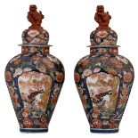 A rare pair of Japanese Arita Imari covered jars, decorated with flower branches and panels with jum