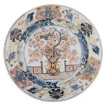 A large Japanese Arita Imari plate, central decorated with a flower basket, the borders with flowers