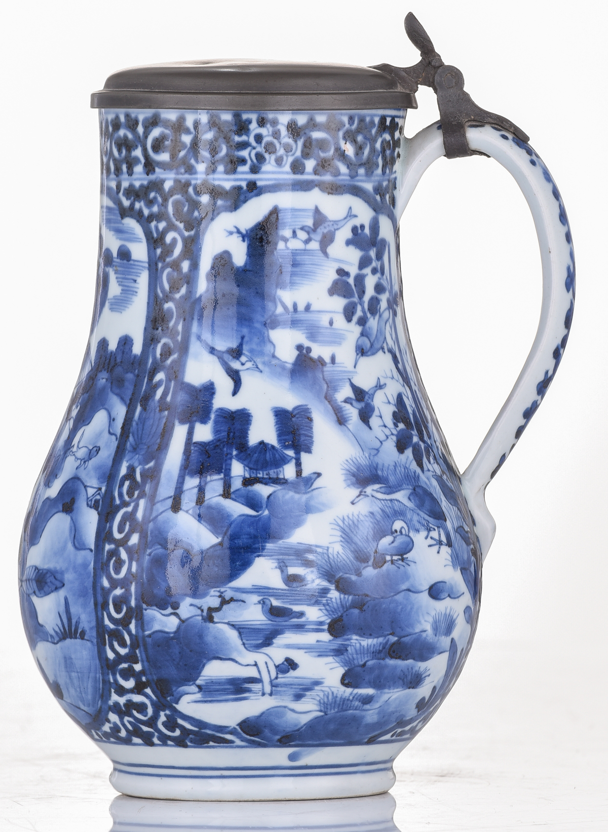 A Japanese Arita Imari blue and white tankard, decorated with scrollwork and panels, filled with fig - Image 2 of 7