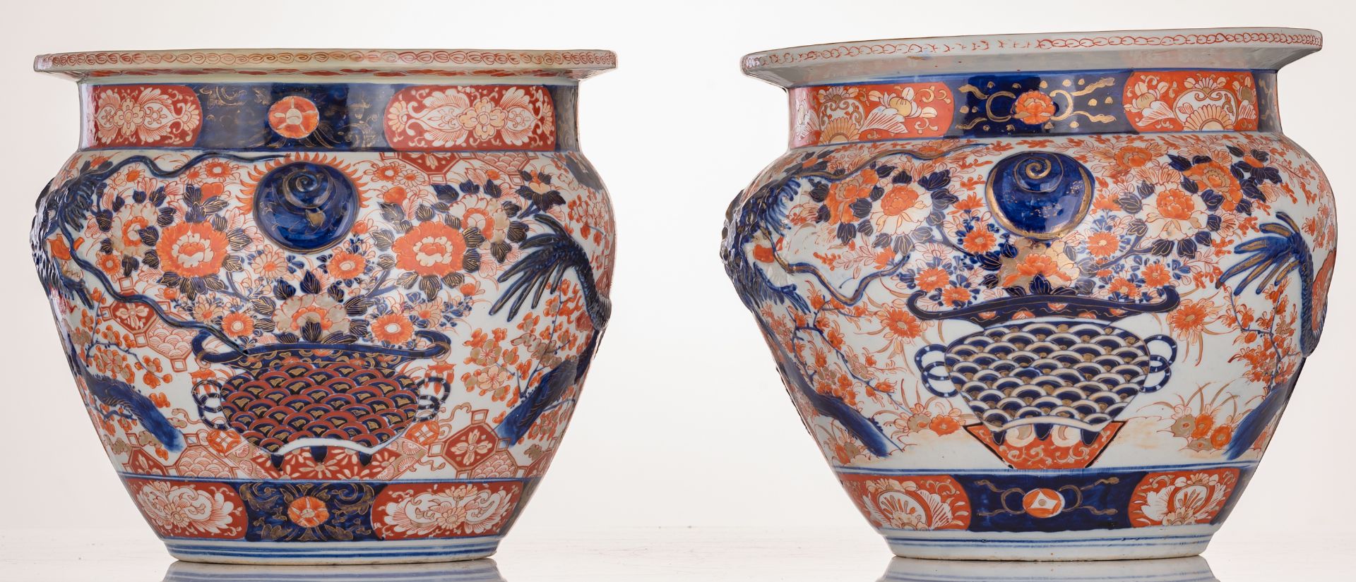 A pair of Japanese Arita Imari fish bowls, relief decorated with flower sprays and a large four claw - Image 3 of 7