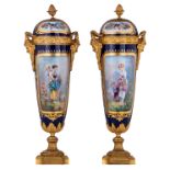A pair of covered vases with gilt bronze mounts, decorated with a mother and child to the front and