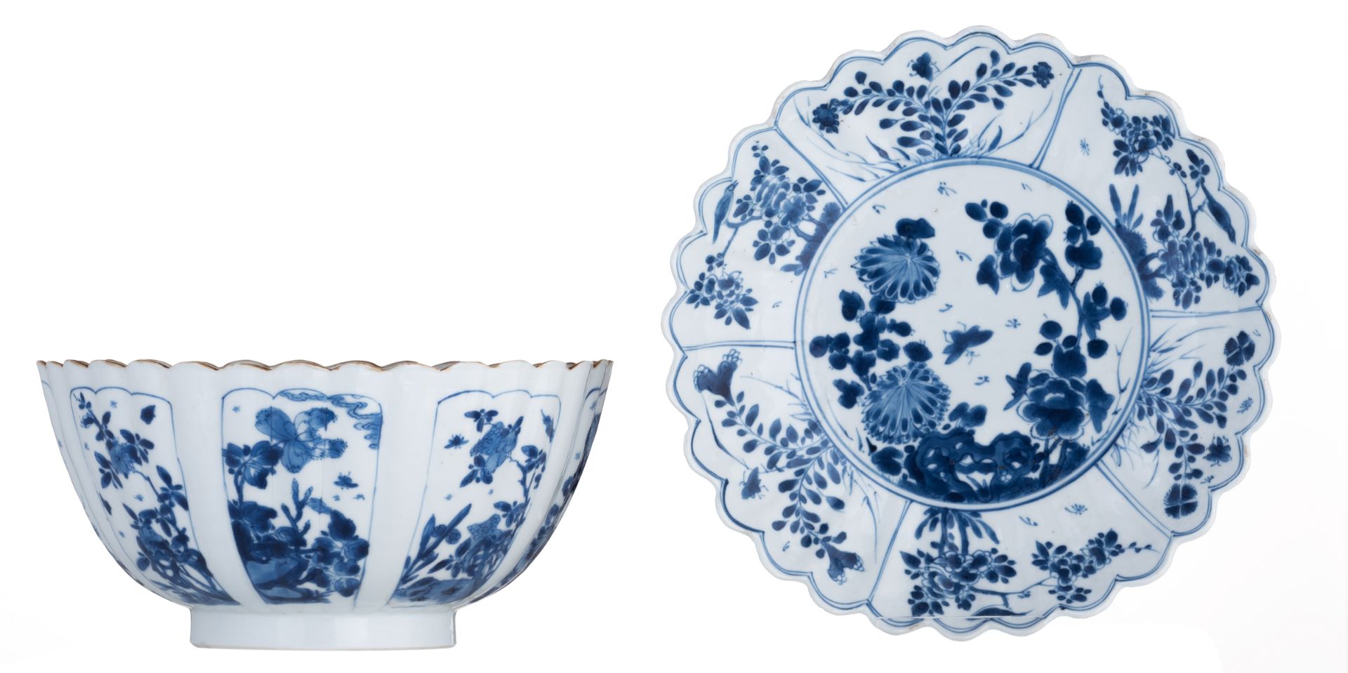 A Chinese blue and white deep fluted bowl and saucer with fluted rim, decorated with panels, filled