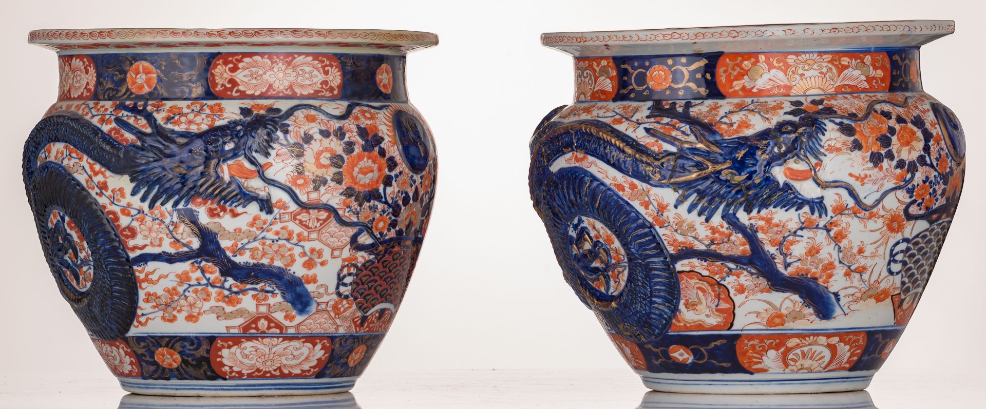 A pair of Japanese Arita Imari fish bowls, relief decorated with flower sprays and a large four claw - Image 2 of 7