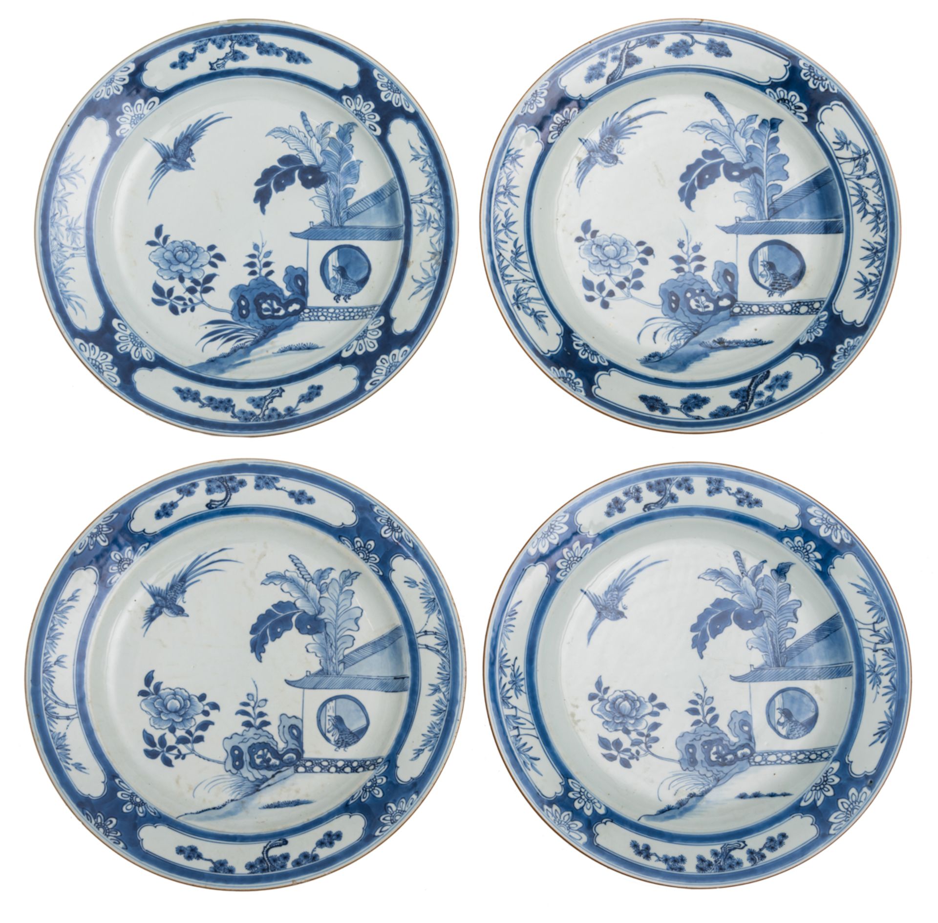 A lot of four large Chinese blue and white plates, decorated in the centre with birds in a garden se