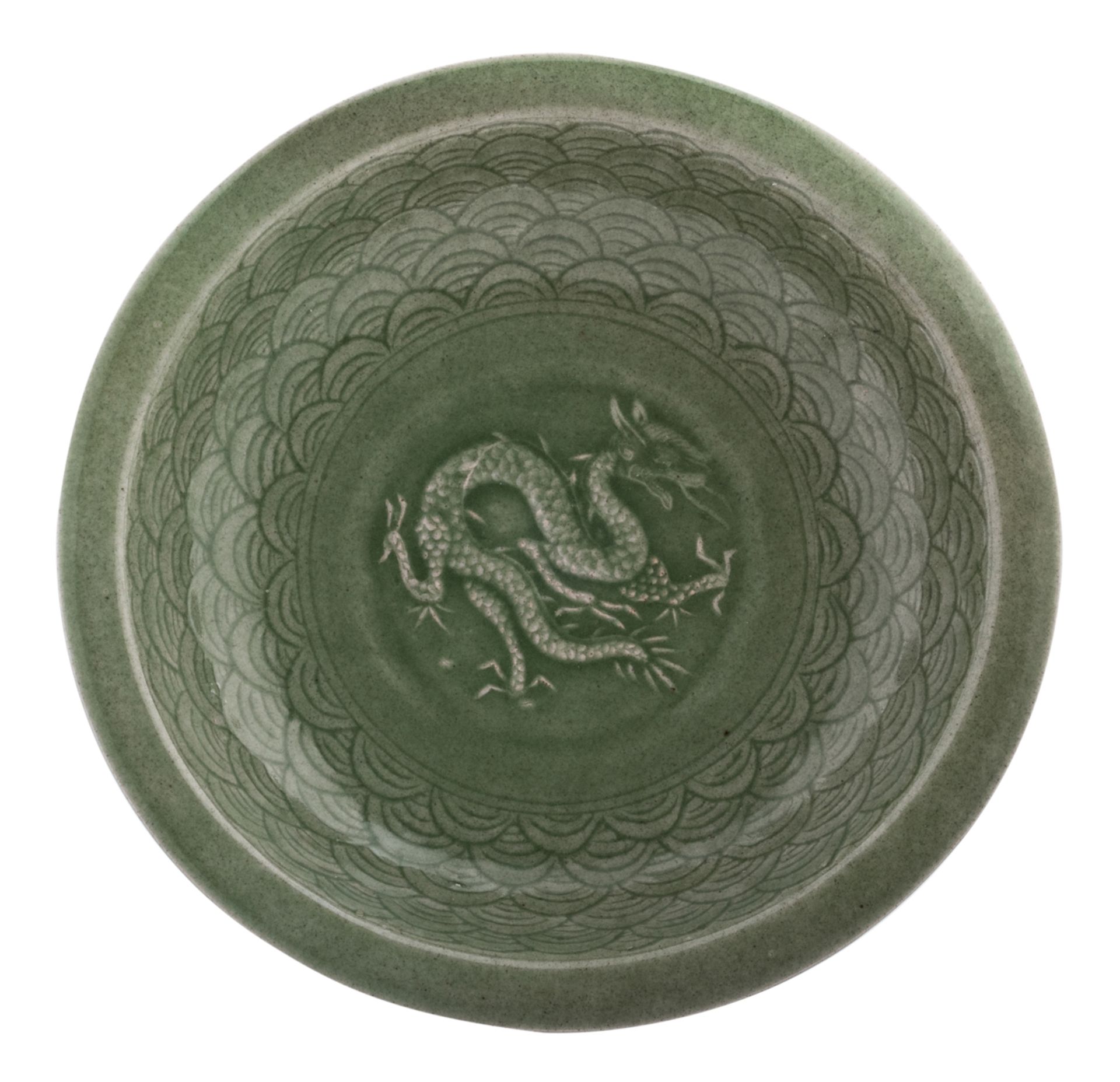 A Chinese celadon stoneware plate, decorated with incised waves and a three clawed dragon in appliqu