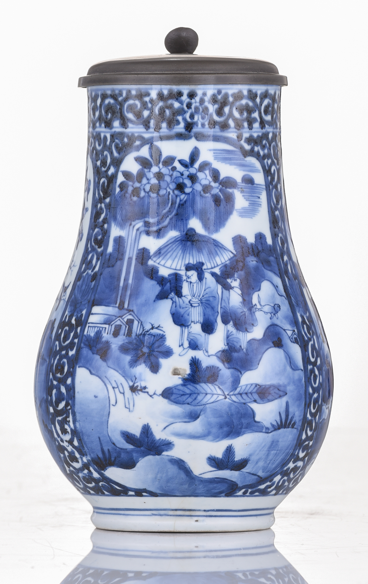 A Japanese Arita Imari blue and white tankard, decorated with scrollwork and panels, filled with fig - Image 5 of 7