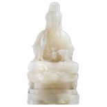 A Chinese carved white onyx stone figure, depicting a seated Guanyin on a lotus base, H 41 - W 20 -