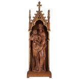 An oak sculpture of the Holy Virgin and child set in a matching Gothic Revival oak and partly gilt o