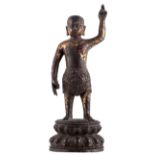 A Chinese gilt and polychrome decorated bronze figure, Ming, H 25,5 cm