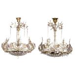 A pair of chandeliers of the sac à perles type with floral white and purple coloured cut glass decor