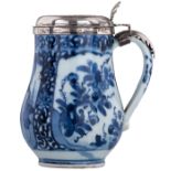 A small Japanese Arita blue and white porcelain tankard with silver cover, decorated with scrollwork