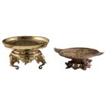 A bronze ornamental footed dish, the well decorated with birds in a landscape, the tripod base eleph