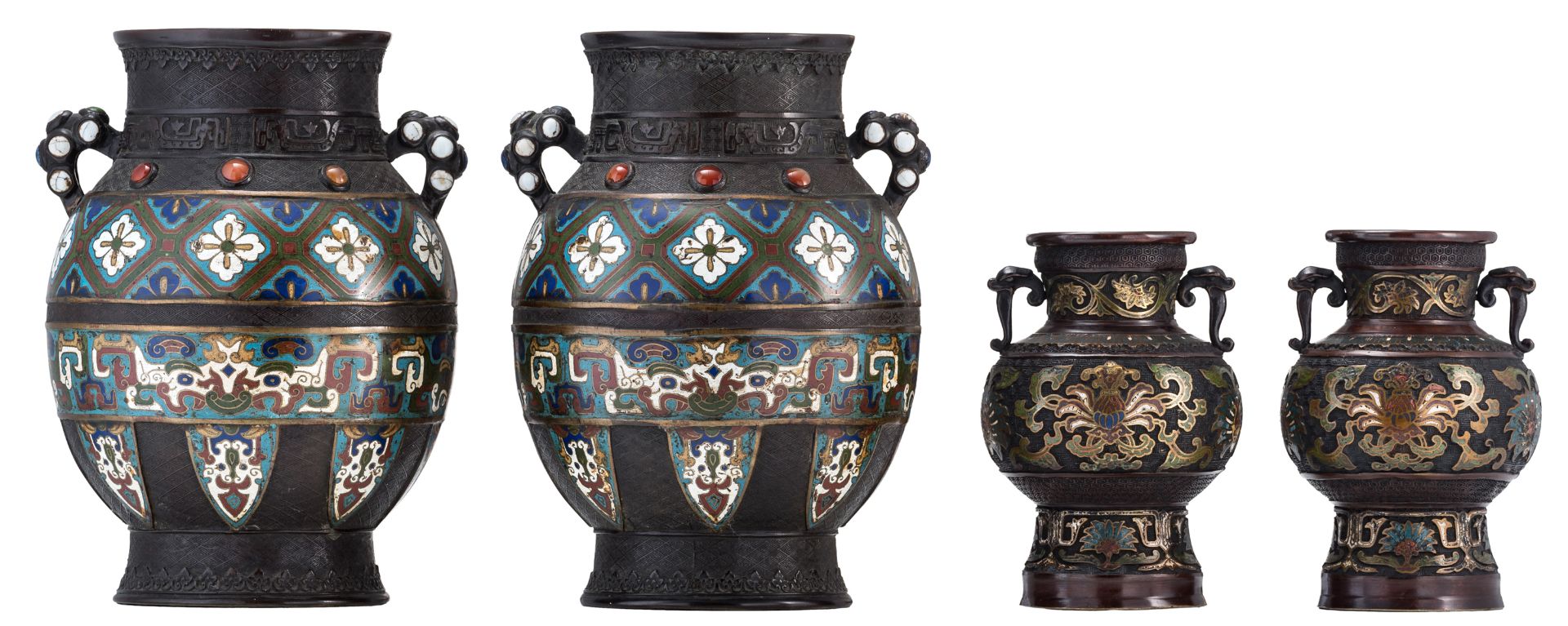 Two pairs of Chinese floral and relief decorated cloisonné and champlevé vases, the cloisonné vases