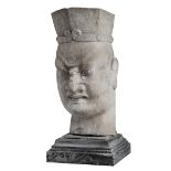 The head of a temple guard, sculpted hardstone, on a black marble base, H 75,5 - 89 cm (with base)