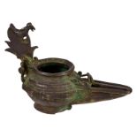 A bronze Khorasan type oil lamp, the grip moulded as a mythical bird on a leaf, H 11,5 cm
