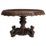 An Oriental richly carved hardwood table, H 76 - ø 136 cm