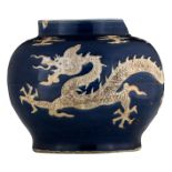 A Chinese blue ground jar, relief decorated with a five clawed dragon chasing the flaming pearl,