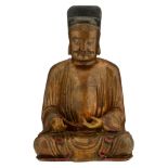 A gilt and lacquered wooden figure depicting a seated Oriental monk in Karana mudra, H 39 cm