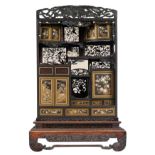 An imposing richly carved Meiji period Japanese cabinet, decorated with mother-of-pearl, ivory and