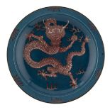 A Chinese bleu poudré and copper red charger, the well decorated with a five clawed dragon amongst