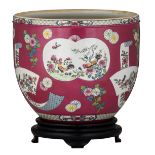 A Chinese ruby ground jardiniere, the roundels decorated with roosters and birds, with a matching