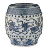 A Chinese blue and white garden seat, decorated with playing kylins, the top with a lotus scroll,