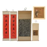 A Chinese ink and stone rubbing example of Emperor Qianlong's writing, with a bone scroll mount,