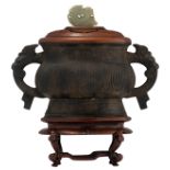 A Chinese archaic Zhou type bronze gui vessel, the handles dragon shaped, the exotic hardwood