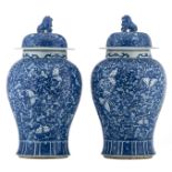 A pair of Chinese blue and white vases and covers, decorated with butterflies and floral motifs, H