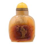 A russet jade snuff bottle, decorated with the Immortal Li Tieguai and a bat, the cover in yellow