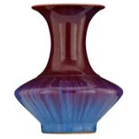 A Chinese flambé-glazed begonia shaped vase, covered in a deep purplish-red glaze streaked in