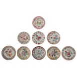 Nine famille rose export dishes, decorated with peonies, a court scene, a cockerel and ducks in a