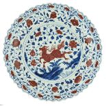 An imposing Chinese cobalt blue and copper red Ming type charger, decorated with floral motifs and a