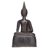 A bronze seated figure on a ditto base, depicting a Laotian Buddha, with black lacquer patina, H