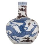 A Chinese cobalt blue and copper red bottle vase, decorated with a dragon amongst clouds, H 41 cm