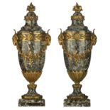 A pair of Neoclassical vert de mer marble castelettes with gilt bronze mounts, the handles shaped as