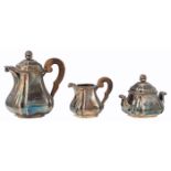 A silver three-part coffee set with walnut handles, consisting of a coffee pot, a creamer and a