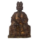 A Chinese patinated bronze figure depicting a seated dignitary holding a sceptre, his hat