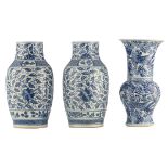 A pair of Chinese floral decorated blue and white porcelain vases; added a ditto blue and white