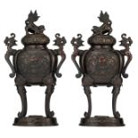 A pair of Japanese bronze relief decorated incense burners, the cover decorated with Shi Shi,