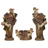 A three part Vienna type creamware Art Nouveau set, relief decorated with angels playing amongst